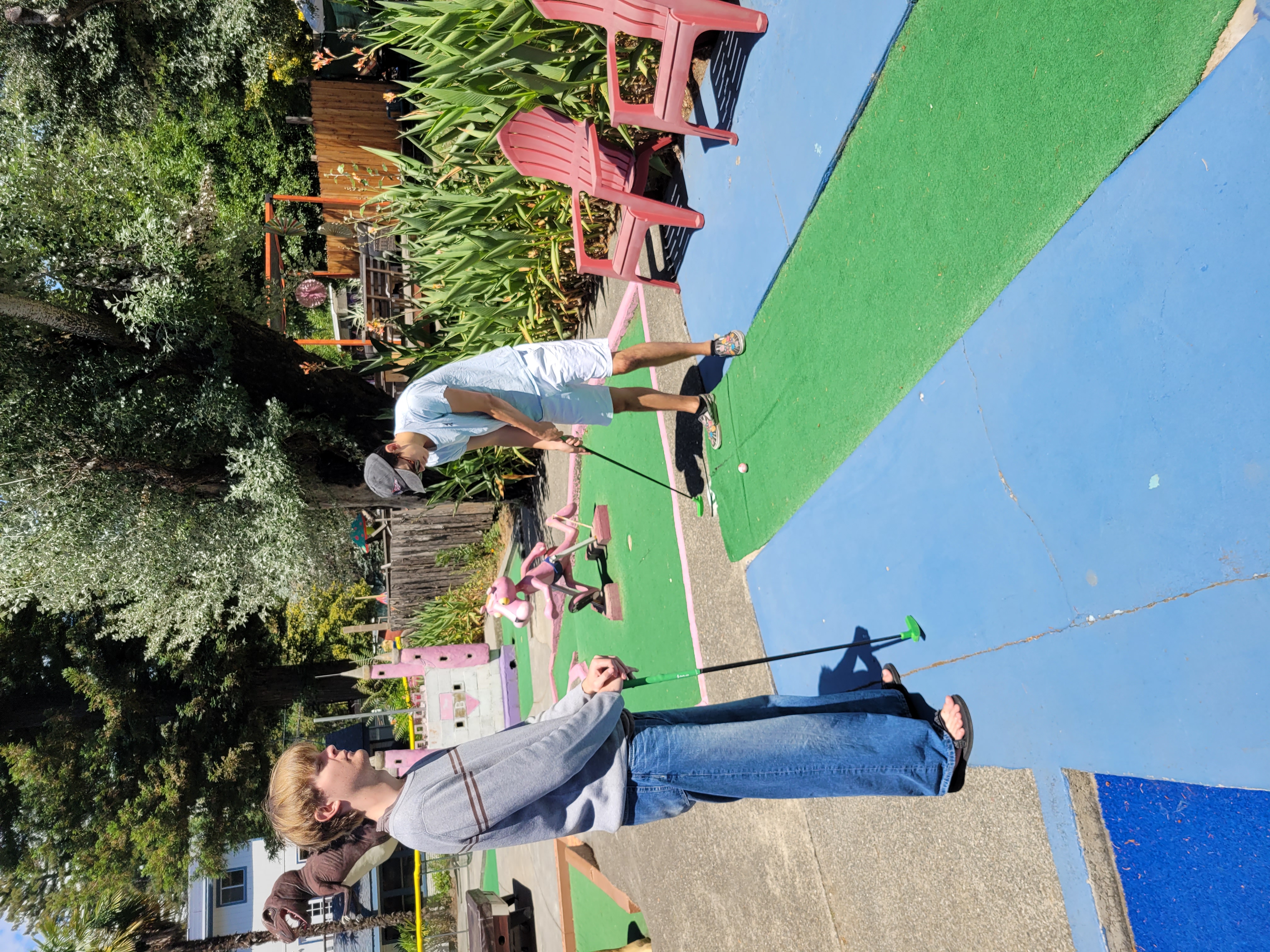 Heath MiniGolfing in a sweater and pants in 80 degree heat